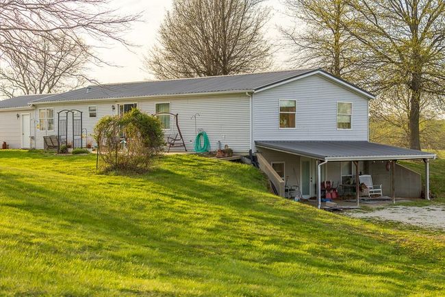 Back of property with metal roof and a yard | Image 70