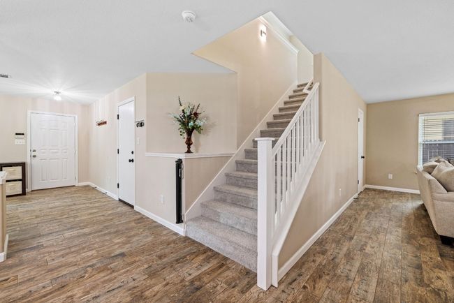 A centrally located staircase leads to the upper level, offering a smooth transition to the loft, guest bedrooms, and primary suite. | Image 24