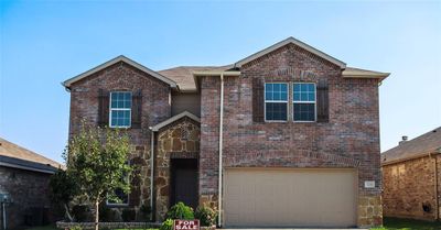 View of property featuring central AC and a garage | Image 1