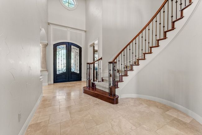 View from living room of front door and staircase. | Image 7