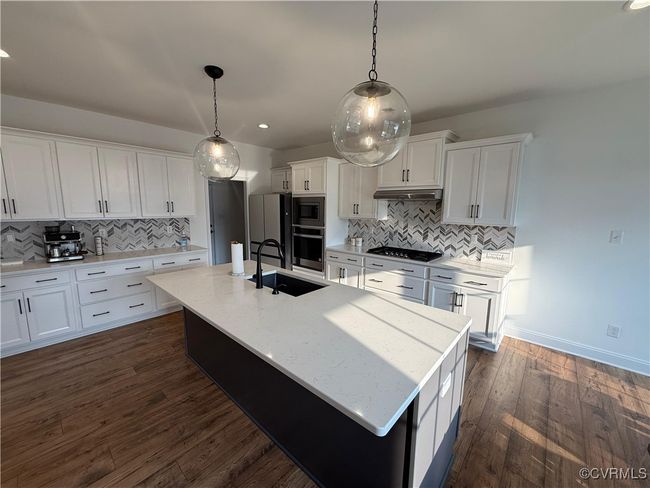 Kitchen with a sink, black cooktop, wall oven, backsplash, and recessed lighting | Image 4