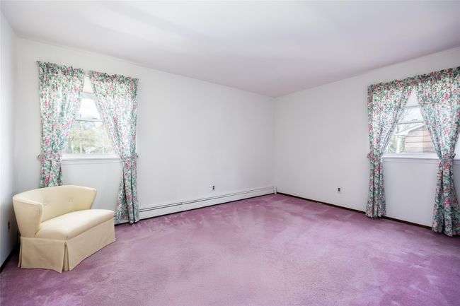 Unfurnished room featuring a baseboard radiator and carpet | Image 23