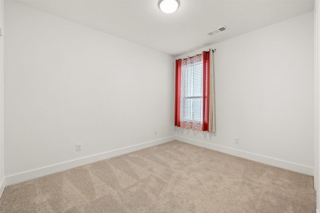 Carpeted spare room featuring baseboards and visible vents | Image 15