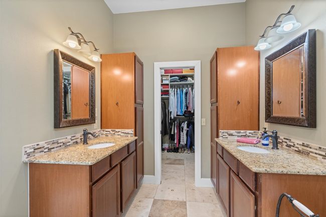 Bathroom with a sink, two vanities, and decorative backsplash | Image 16