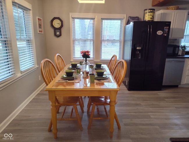 dining room with baseboards and wood finished floors | Image 9