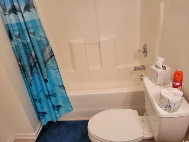 Full bathroom featuring toilet and shower / tub combo | Image 40
