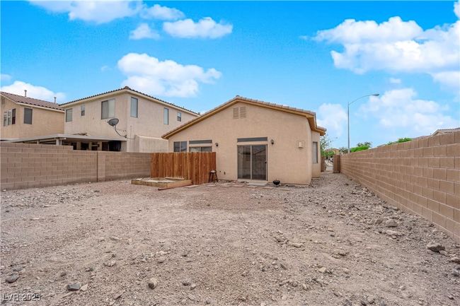 Rear view of house featuring a fenced backyard and stucco siding | Image 17