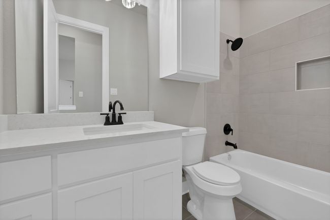 Full bathroom featuring vanity, tub / shower combination, and tile patterned flooring | Image 26