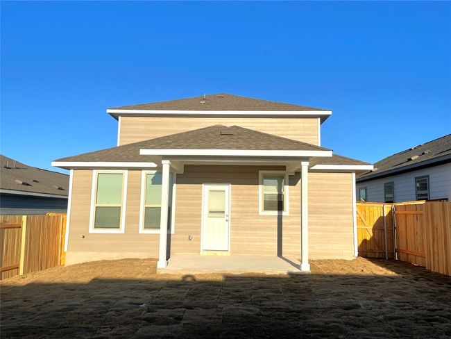 Rear view of property with a fenced backyard, a patio area, and a shingled roof | Image 23