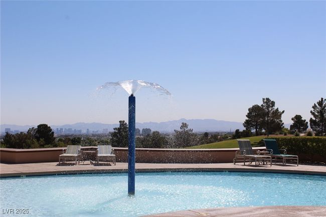 Community pool with a patio area and a mountain view | Image 25