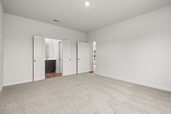 Bedroom featuring carpet flooring, ensuite bath, and recessed lighting | Image 4
