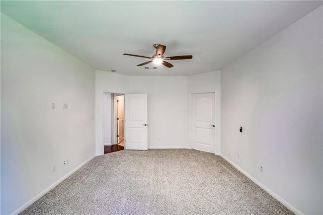 Unfurnished bedroom featuring carpet flooring and a ceiling fan | Image 17