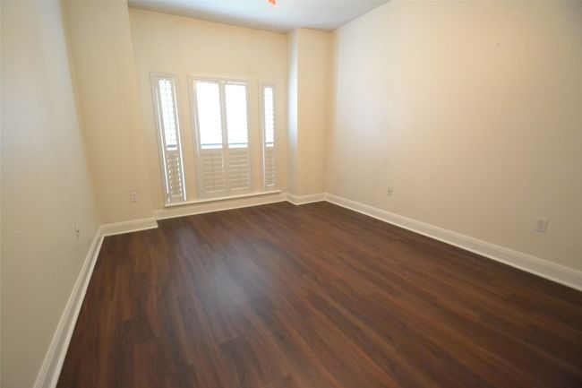 Spare room with dark wood finished floors and baseboards | Image 24