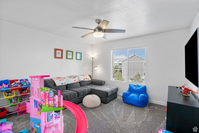 Playroom with baseboards, carpet, and ceiling fan | Image 20