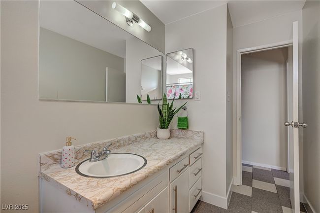 Bathroom with baseboards, vanity, and tile patterned floors | Image 31