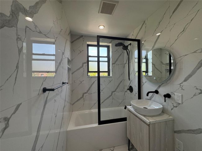 Bathroom featuring enclosed tub / shower combo and vanity | Image 10