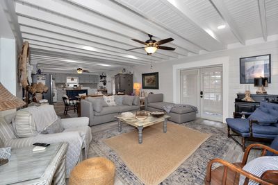 Living Room - LVP flooring, fireplace, ceiling fan, double doors leading to screened porch overlooking water | Image 3