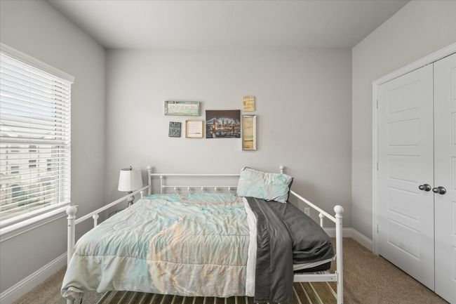 Bedroom with multiple windows and carpet floors | Image 17