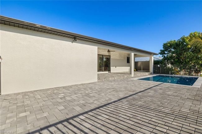 View of swimming pool featuring a patio area | Image 38