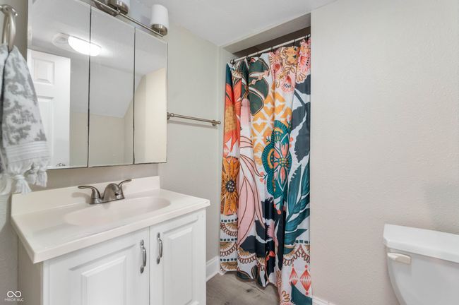 full bathroom with vanity, baseboards, curtained shower, toilet, and wood finished floors | Image 15