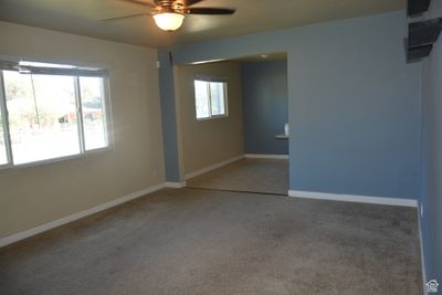 Carpeted empty room with ceiling fan | Image 2