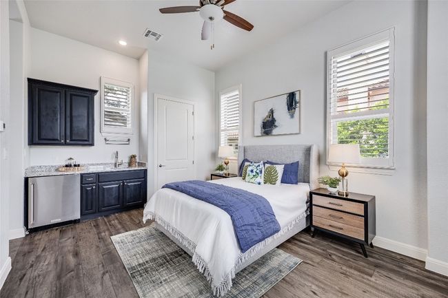 Casita Bedroom featuring refrigerator, wet bar, dark wood finished floors, recessed lighting, and ceiling fan | Image 23