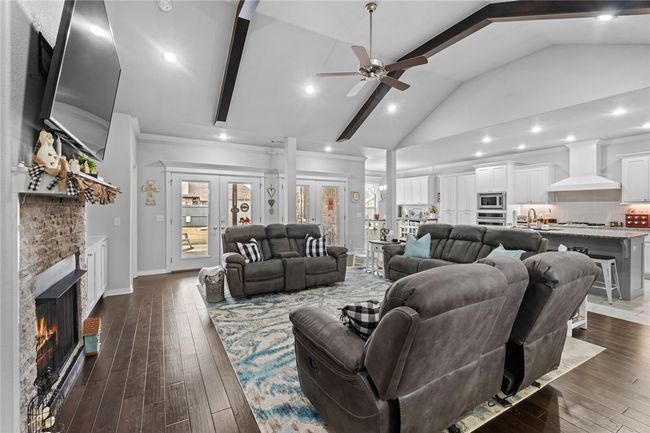 Very nice open design. Love the beams. Real wood floors. Gas fireplace, Double French doors so you can really open up your home for entertaining. | Image 15