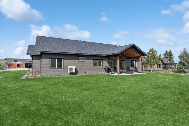 Back of property featuring a shingled roof, a patio area, and a lawn | Image 5
