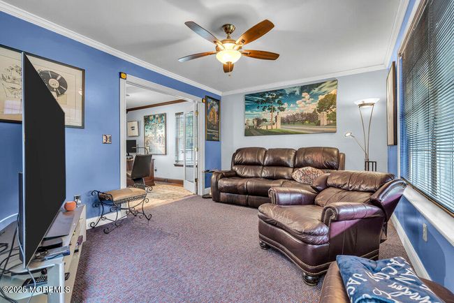 Formal living room leads to office. | Image 9