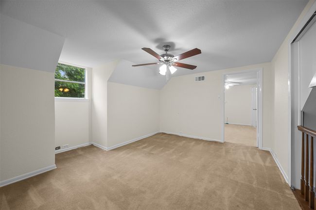 Bonus room featuring light carpet, a ceiling fan, lofted ceiling, and baseboards | Image 24