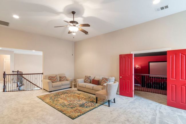 Carpeted living area featuring ceiling fan and recessed lighting | Image 27