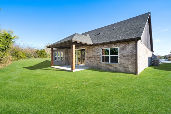 Back of property with a lawn, cooling unit, and a patio | Image 23