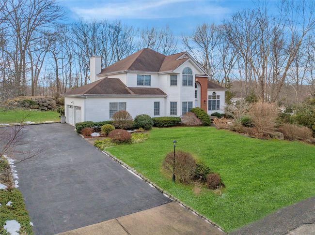 View of front of property featuring a garage and a front yard | Image 30