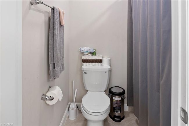 Full bathroom featuring baseboards, toilet, tile patterned flooring, and a shower with curtain | Image 29