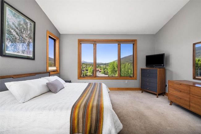 Bedroom with light carpet and lofted ceiling | Image 9