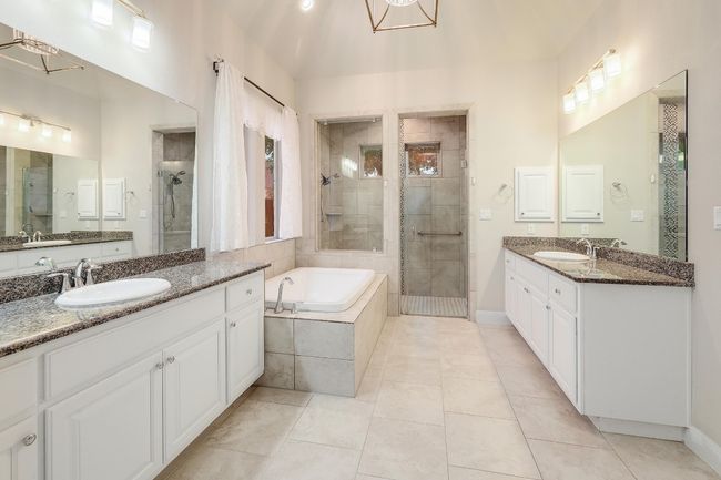 Full bath with a shower stall, two vanities, a bath, and tile patterned floors | Image 19