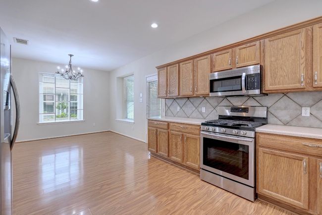 Kitchen opens to the dining area | Image 11