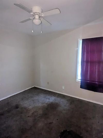 Carpeted spare room with ceiling fan | Image 2