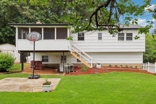 View of yard with a patio, a sunroom, and stairs | Image 31