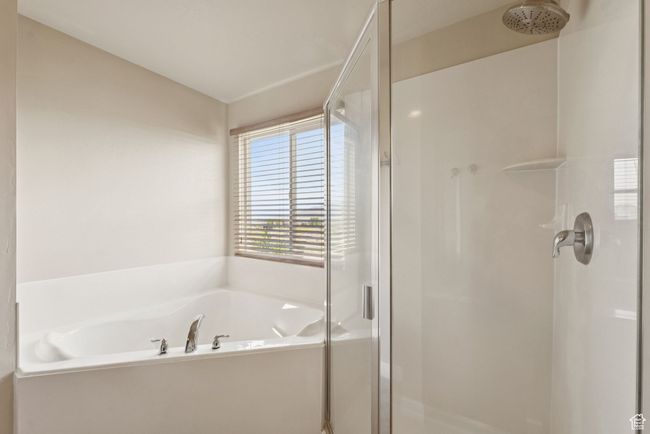 Primary full bathroom featuring a stall shower and a garden tub | Image 28