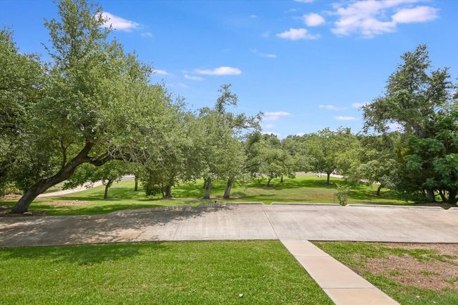 View looking south and paved circular driveway. | Image 9