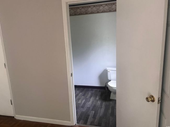 Bathroom featuring wood finished floors and toilet | Image 17