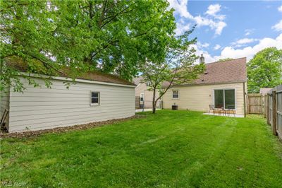 Enjoy family time in the private backyard with lots of greenery and a chainlink fence perfect for kids and pets. | Image 3