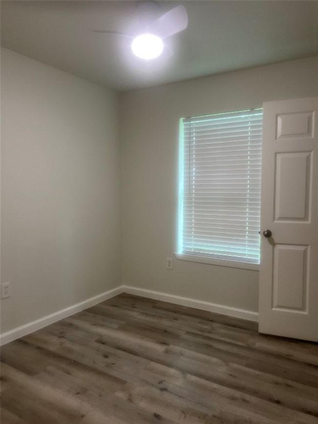 Empty room with wood finished floors and baseboards | Image 9