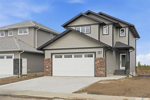 Contemporary two-story exterior featuring a covered front entry and a two-car garage | Card Image
