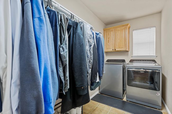 Laundry area with cabinet space, washer and clothes dryer, and tile patterned floors | Image 30