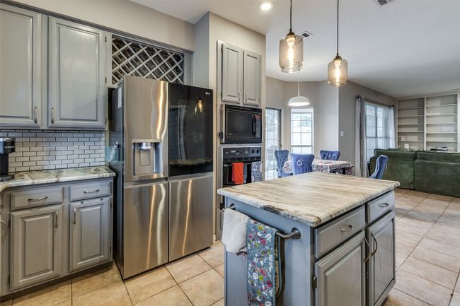 Large patio doors to oversized patio and 2nd dining area, large pantry make this home perfect for large indoor/outdoor parties. | Image 10