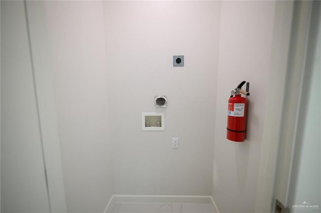 Washroom featuring hookup for an electric dryer, washer hookup, baseboards, and marble finish floors | Image 18
