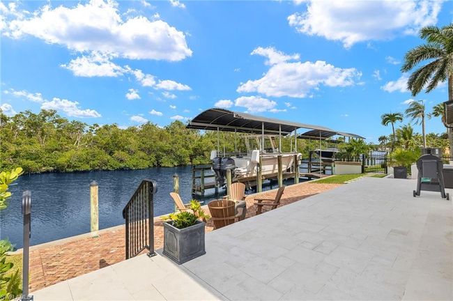 Dock area with boat lift and a water view | Image 45