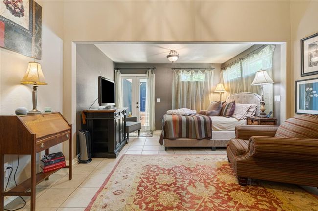 Bedroom with light tile patterned floors, french doors, and baseboards | Image 22